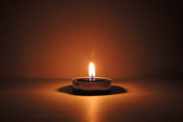 Single Candle Processing the Final Paycheck for a Deceased Employee