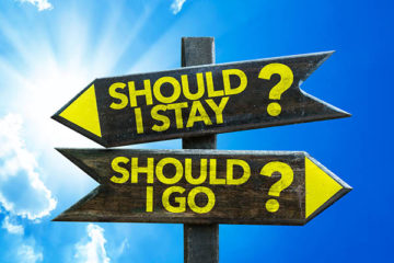 Should I Stay_ Should I Go_ signpost with sky background New Year, New Strategy: “Stay Interviews” to Avoid “Exit Interviews”