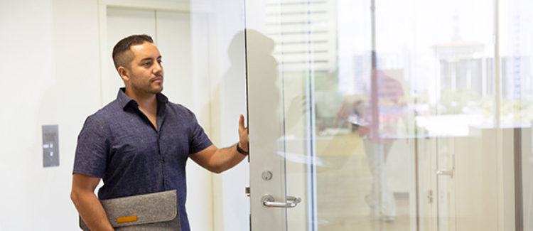 Man entering glass office door